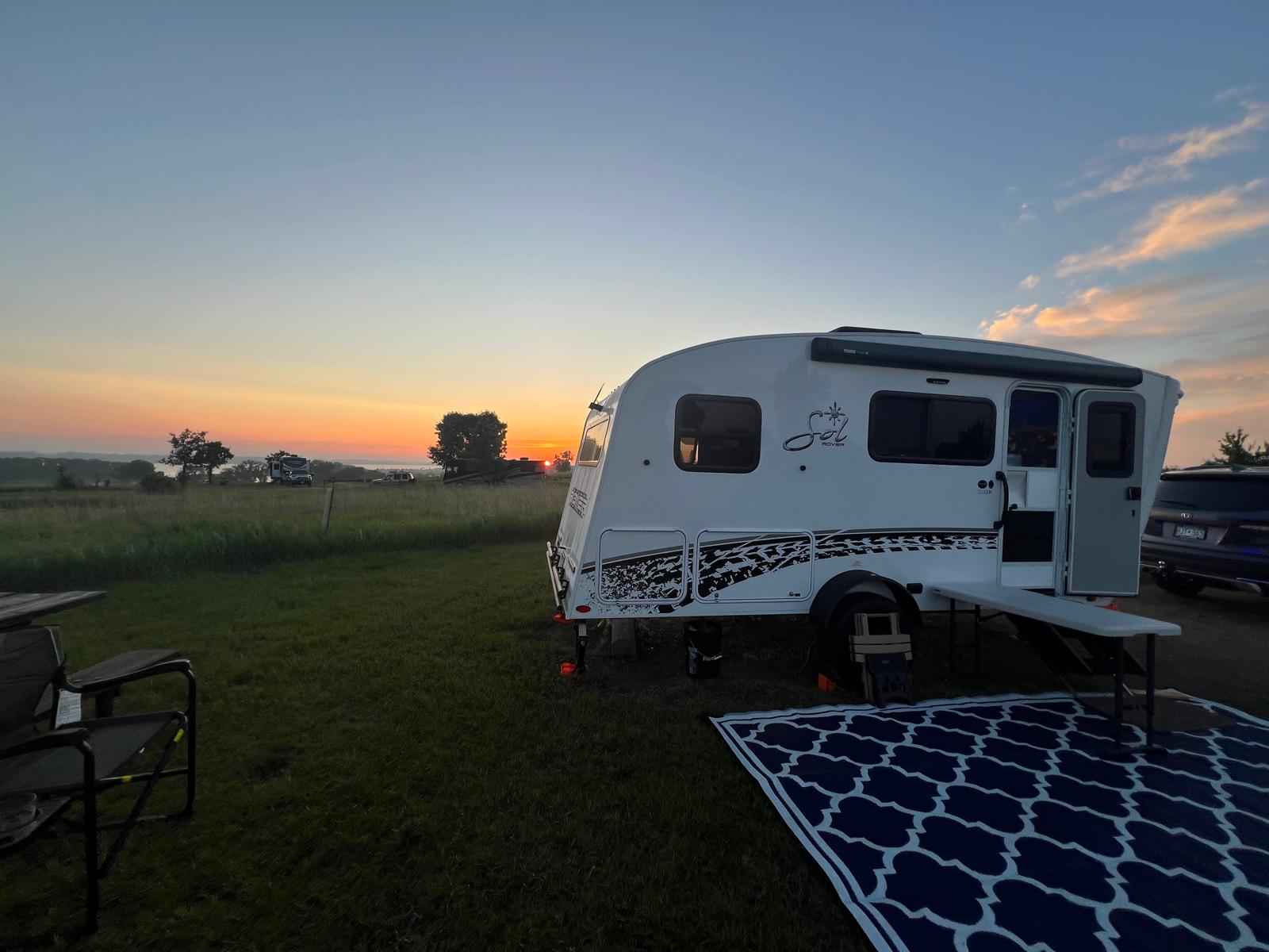 Camper at sunset in a peaceful field